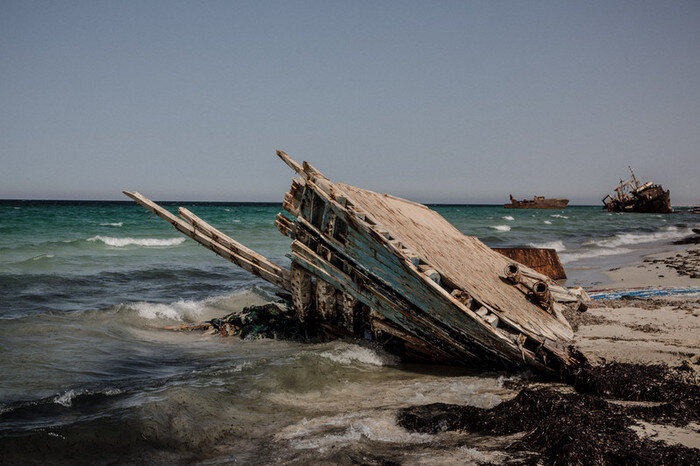 Die Überreste eines Flüchtlingsboots am Strand von Zuwara, Libyen